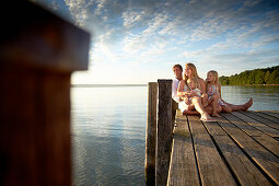 Family on a jetty at lake Starnberg, Upper Bavaria, Bavaria, Germany