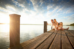 Family on a jetty at lake Starnberg, Upper Bavaria, Bavaria, Germany