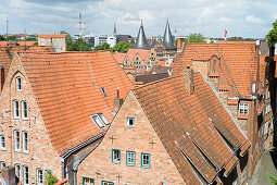 View over historic city with Holsten Gate in background, Lubeck, Schleswig-Holstein, Germany