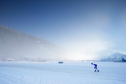 Ice speed skater on lake Weissensee, Alternative Eleven cities tour, Weissensee, Carinthia, Austria