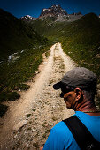 Hiker on path, Piz Kesch in the background, Val d'Es-cha, Upper Engadine, Switzerland