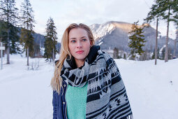 Young woman in snow, Spitzingsee, Upper Bavaria, Germany