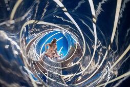 Mother and child sliding down a modern slide, Swabian Alb, Baden-Wuerttemberg, Germany