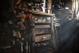 warm light shining through the window of a chaotic blacksmiths workshop, Vellberg, Schwaebisch Hall, Baden-Wuerttemberg, Germany