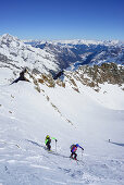 Man and woman back-country skiing ascending towards Schneespitze, Schneespitze, valley of Pflersch, Stubai Alps, South Tyrol, Italy