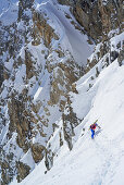 Woman back-country skiing ascending to La Forcellina, Col Sautron, Valle Maira, Cottian Alps, Piedmont, Italy