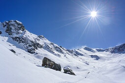 Several persons back-country skiing ascending towards Monte Faraut, Monte Faraut, Valle Varaita, Cottian Alps, Piedmont, Italy