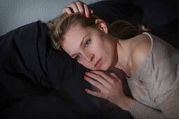 Young woman relaxing on the sofa, Pensive