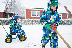 Boys playing in the snow, Cuxhaven, North Sea, Lower Saxony, Germany