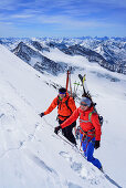 Two persons back-country skiing ascending with ice axe and crampons towards Dreiherrnspitze, Dreiherrnspitze, valley of Ahrntal, Hohe Tauern range, South Tyrol, Italy