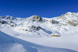Snow covered alpine hut with Monte Reghetta, Monte Faraut and Monte Gabel, Rocca La Marchisa, Valle Varaita, Cottian Alps, Piedmont, Italy