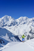 Frau auf Skitour steigt zur Vertainspitze auf, Königsspitze und Zebru im Hintergrund, Vertainspitze, Suldental, Ortlergruppe, Südtirol, Italien