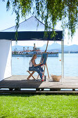 Young Woman with artist's easel painting, Fraueninsel, Chiemsee, Bavaria, Germany