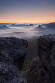 View from Gleitmannshorn over the small Zschand at dawn with rocks in the foreground, Kleiner Winterberg, National Park Saxon Switzerland, Saxony, Germany