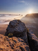 View from Gleitmannshorn over the small Zschand with fog at sunrise with rocks in the foreground, Little Winterberg, National Park Saxon Switzerland, Saxony, Germany