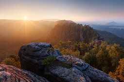 Sunrise over the Saxon Switzerland National Park, with view to the Mittelwinkel in the Schrammstein rock formation in late summer, Elbe valley and Zirkelstein in the background, Saxony, Germany