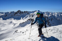 Mountaineer shortly before the summit of the Schwarzhorn (3146 m), summits in the background from left to right: Piz Radoent, Raduener Rothorn, Piz Palue, Piz Bernina, Grisons, Switzerland, Europe
