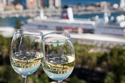Reflection of cruise ship MS Deutschland (Reederei Peter Deilmann) in wine glasses, Malaga, Costa del Sol, Andalusia, Spain