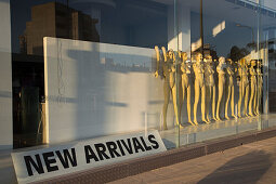 Naked mannequin figures with separated arms in window of empty clothes shop, Larnaca, Larnaca, Cyprus