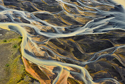 Aerial view of colorful meanders of  glacial river Thjorsa floating over the lava area (sander) Landeyarsandur, South Iceland, Iceland, Europe