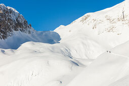 Backcountry skiers ascending Hochkarfelderkopf, Tennengebirge mountains, Salzburg, Austria