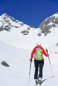 Woman back-country skiing ascending towards Scharnitzsattel, Scharnitzsattel, Lechtal Alps, Tyrol, Austria