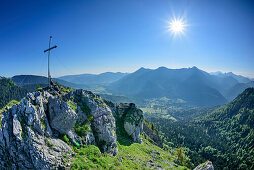 Person sitting at summit of Leonhardstein, view to Tegernsee Mountains, Leonhardstein, Bavarian Alps, Upper Bavaria, Bavaria, Germany