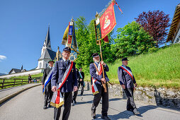 Procession during religious festival of Feast of Corpus Christi, church of Kreuth in background, Kreuth, Bavarian Alps, Upper Bavaria, Bavaria, Germany