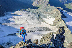 Woman climbing ridge Stuedlgrat towards Grossglockner, Stuedlgrat, Grossglockner, High Tauern, East Tyrol, Austria