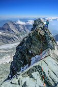 Woman descending over normal route from Grossglockner, Grossglockner, High Tauern, East Tyrol, Austria