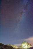 Stary sky with milky way above hut Rifugio Rosetta, Pala range, Dolomites, UNESCO World Heritage Dolomites, Trentino, Italy