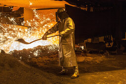 Salzgitter Steelworks, steel worker in protective suit, sparks, glowing heat, industry, Lower Saxony, Northern, Germany