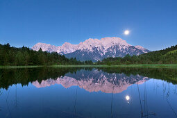 Full moon reflecting at Luttensee, view to Karwendel, near Mittenwald, Werdenfels region, Bavaria, Germany