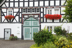 Half-timbered house in the village Kirchveischede, near Lennestadt, Rothaargebirge, Sauerland region, North Rhine-Westphalia, Germany