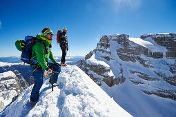 Two men standing on the peak of Cima Falkner in the backdrop Cima Brenta, Skitour, Brenta Gebirge, Dolomites, Trentino, Italien