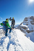 Two men standing on the peak of Cima Falkner in the backdrop Cima Brenta, Skitour, Brenta Gebirge, Dolomites, Trentino, Italien