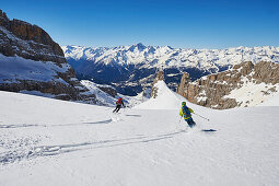 Two Menn Skiing on the way down to the skiresort Madonna di Campiglio Ski, on the Horizon you can see Adamello, Skitour, Brenta Gebirge, Dolomites, Trentino, Italien