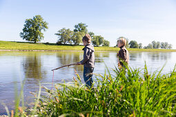 Boys fishing, Family bicycle tour along the river Elbe, adventure, from Torgau to Riesa, Saxony, Germany, Europe