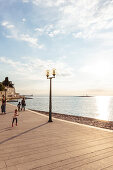 people walking at the waterfront of Porec, Istria, Croatia