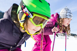 girl and boy skiing on the slope, Pfronten, Allgaeu, Bavaria, Germany