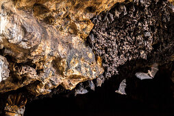 Bat colony in front of a cave entrance, near Padangbay, Bali, Indonesia
