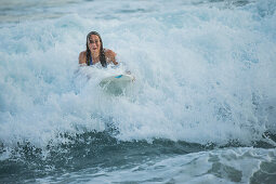 Young female surfer riding a wave, Sao Tome, Sao Tome and Principe, Africa