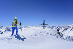 Woman back-country skiing walking to summit of Winnebacher Weisserkogel, Winnebacher Weisserkogel, Sellrain, Stubai Alps, Tyrol, Austria