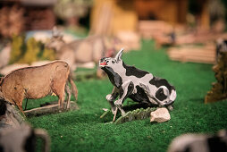 cow getting up at mechanical crib at cemetery in Blaubeuren, Alb-Danube district, Swabian Alb, Baden-Wuerttemberg, Germany