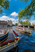 Tourist boats on the Amstel in Amsterdam, Netherlands