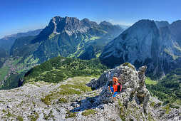 Woman looking towards Ehrwald and Wetterstein range with Zugspitze, Ehrwalder Sonnenspitze, Mieming range, Tyrol, Austria