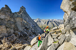 Man and woman climbing towards Richterspitze, Richterspitze, Reichenspitze group, Zillertal Alps, Tyrol, Austria