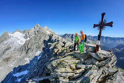 Man and woman standing at summit of Richterspitze, Reichenspitze and Gabler in background, Richterspitze, Reichenspitze group, Zillertal Alps, Tyrol, Austria