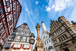 The house Jagstheimerhaus and the town hall with the market fountain at the town hall square, Rothenburg ob der Tauber, Bavaria, Germany