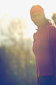 Young female runner outside in the nature on a sunny day, Fuessen, Bavaria, Germany